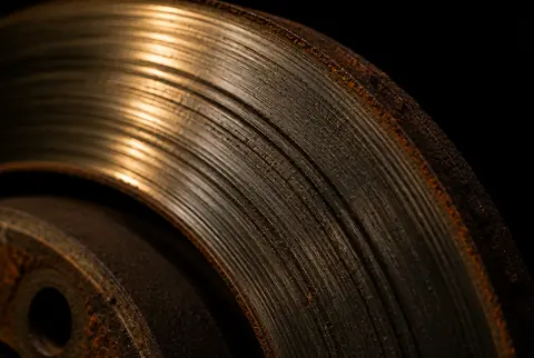 A worn brake rotor with scoring grooves