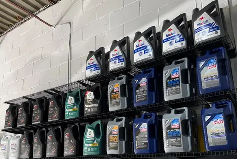 Shelves of motor oil on the wall at GTS Auto Repair