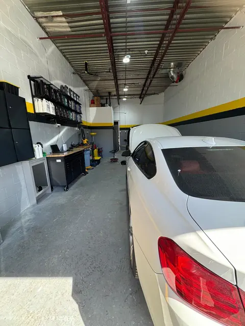 Inside the GTS Auto Repair unit with a white BMW