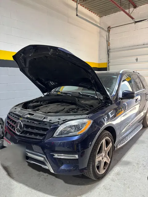 A blue Mercedes-Benz ML with the hood open at GTS Auto Repair